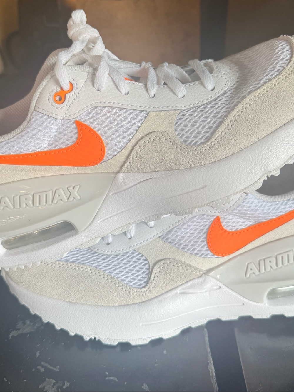 Nike Women’s White Sneakers with Bright Orange Swoosh